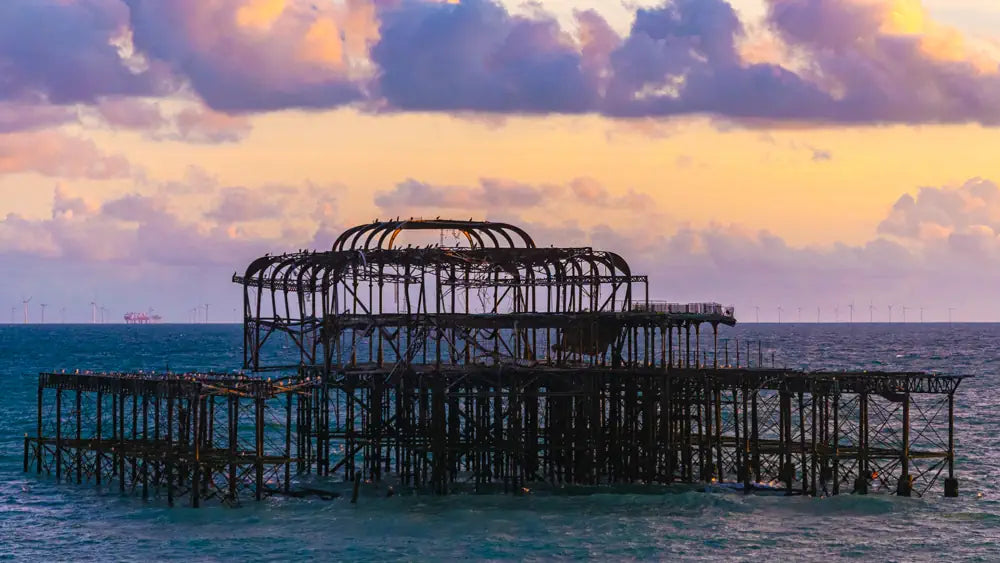 uk wall art of a weathered pier at sunset over calm sea, coastal architecture photography
